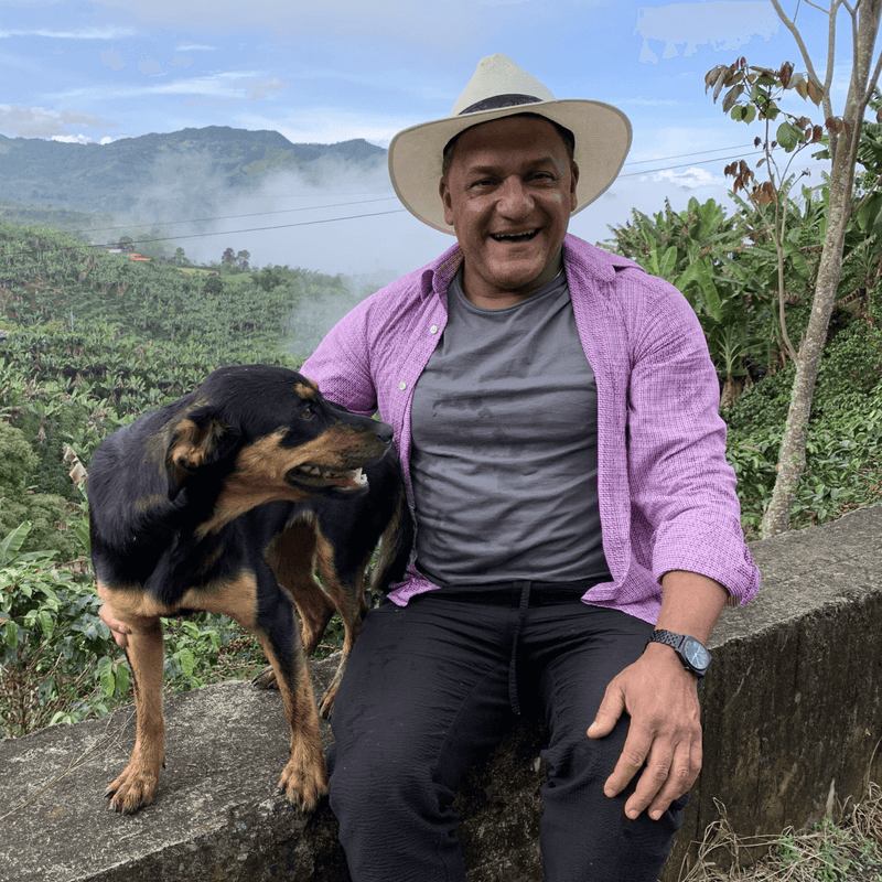 esnayder cuartas and dog with coffee farm vista in background